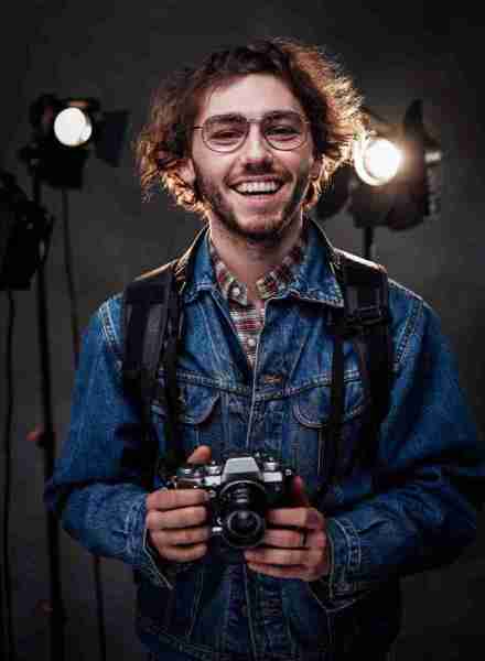 young-photographer-holds-a-camera-studio-portrait-2025-01-26-11-29-30-utcResized_8_11zon